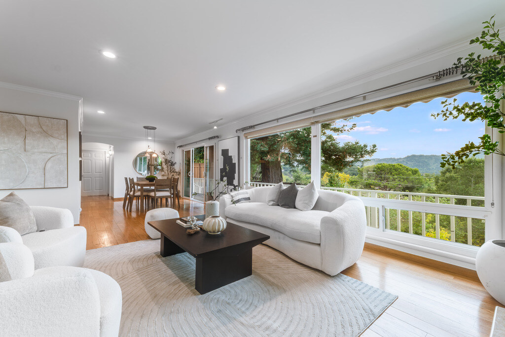 Elegant light-filled living room with broad hillside views