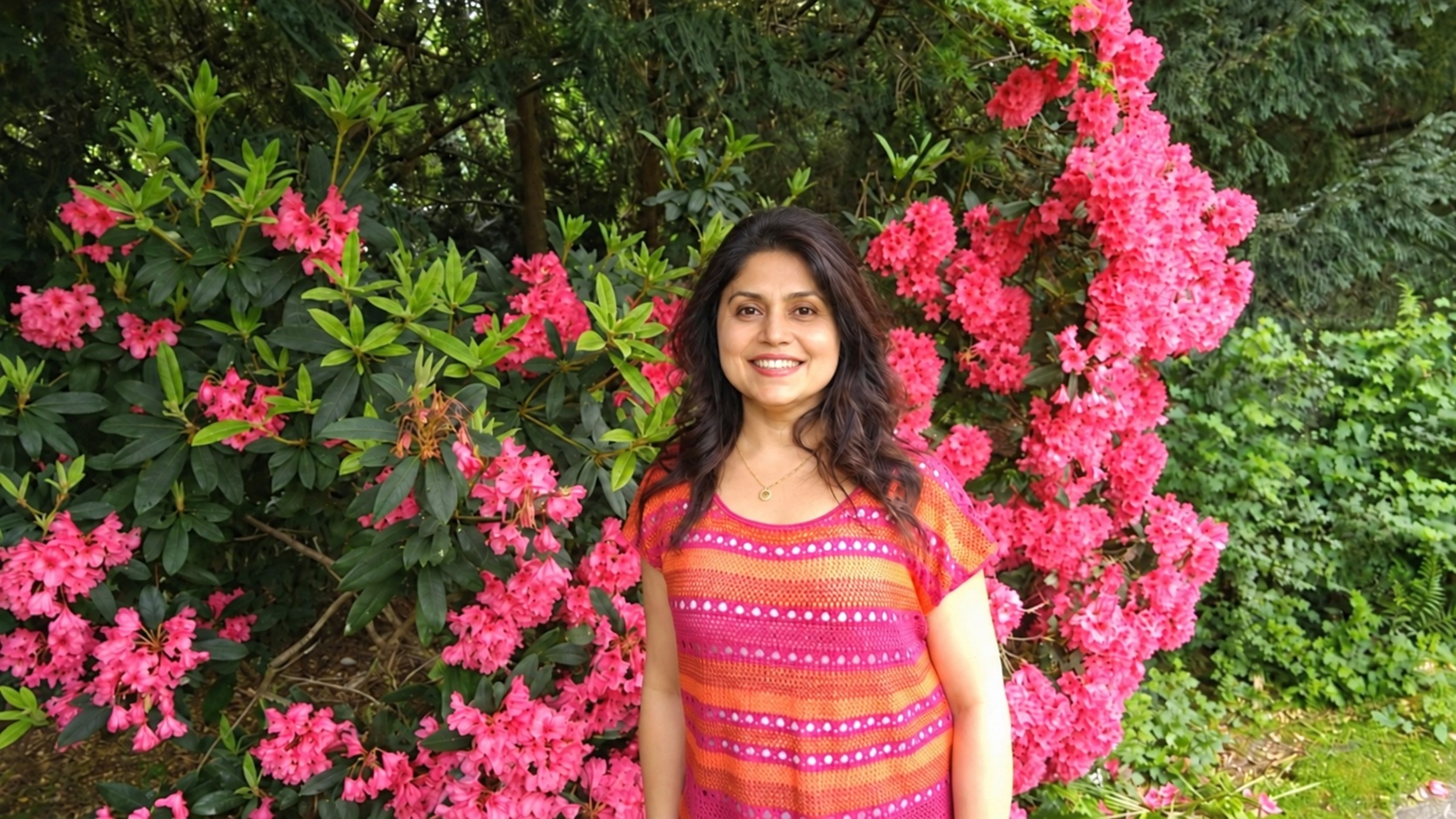 Shiraz Zack standing among pink flowers
